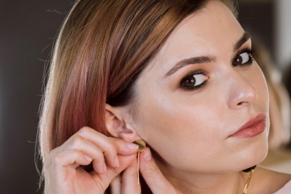 Woman touching her ear