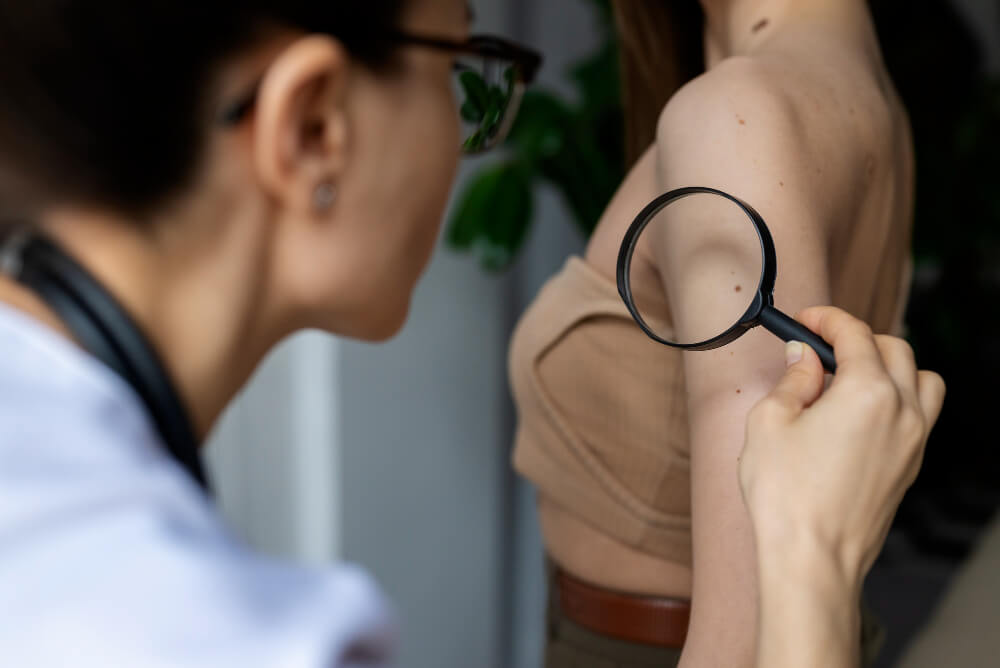 A dermatologist examining a patient’s elbow